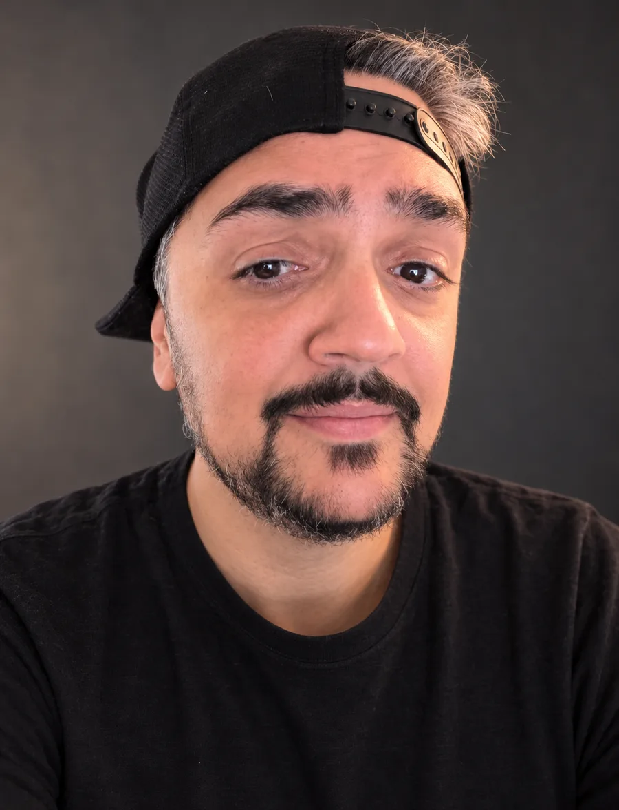 Frank Hammed, backwards cap, black tee, giving a slightly skeptical half smile